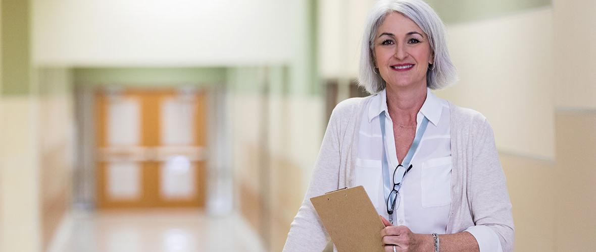 School Principal standing in hallway