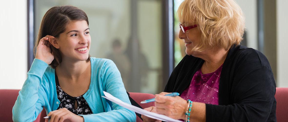 School Counselor talks with young student