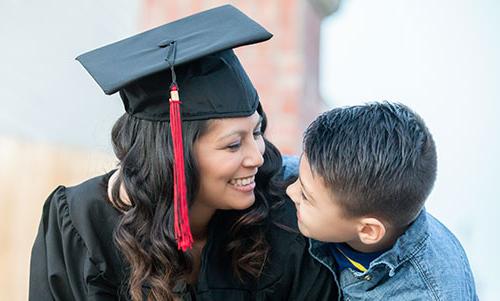 A graduate and her child celebrate on graduation day